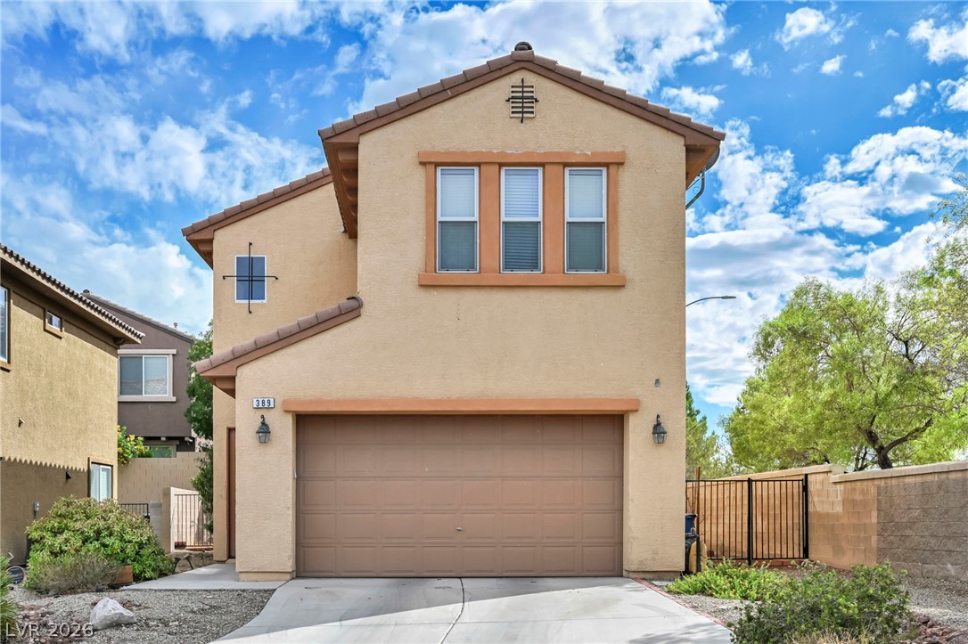 389 Fringe Ruff Drive Las Vegas, NV 89148 - Photo 35 of 53 Warm stucco exterior displays a tiled roof and integrated multi-car garage.