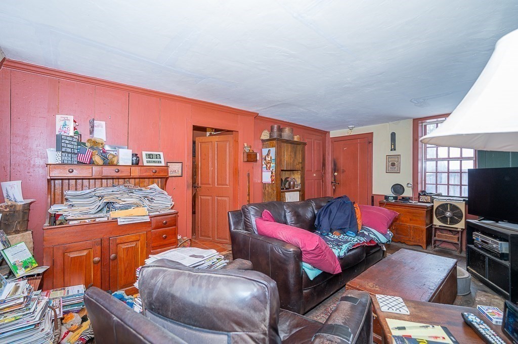 8 Old Common Road Sutton, MA 01590 - Photo 8 of 35 a living room with furniture a bookshelf and a window