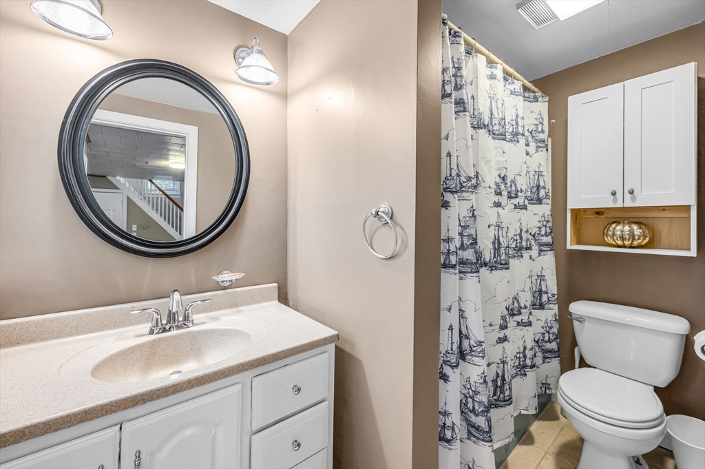 10 Kelsey Street East Longmeadow, MA 01028 - Photo 16 of 28 a bathroom with a granite countertop toilet a sink and a mirror