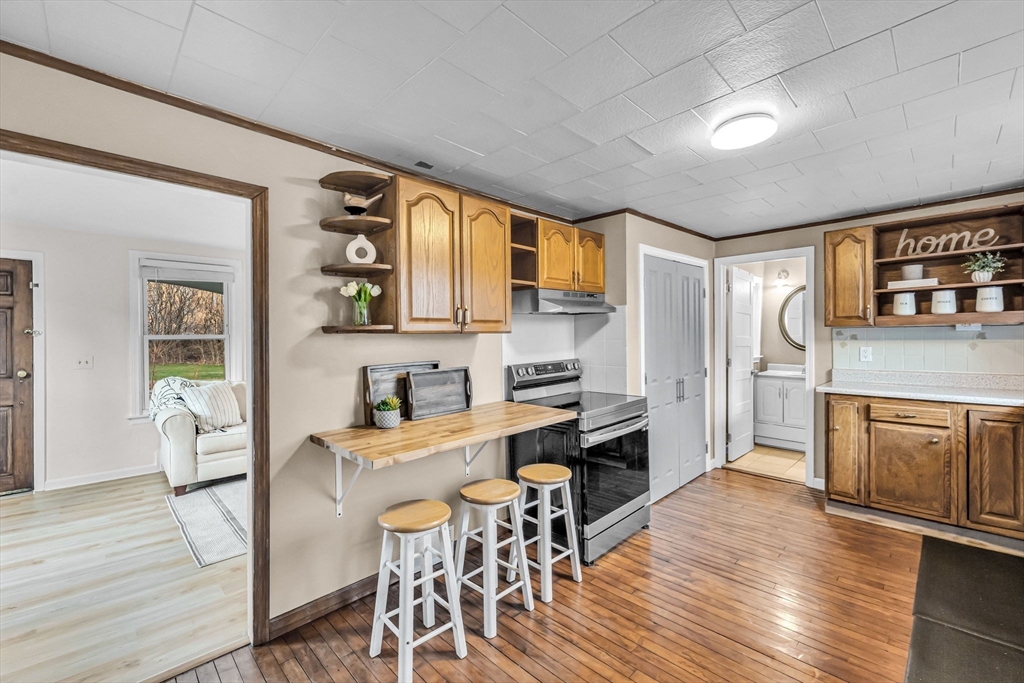 10 Kelsey Street East Longmeadow, MA 01028 - Photo 8 of 28 a kitchen with a table chairs refrigerator and cabinets