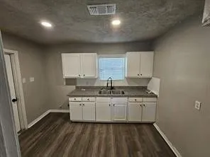 a kitchen with a sink stove and cabinets