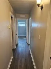 a view of a hallway with wooden floor