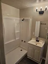 a bathroom with a sink a tub and a mirror