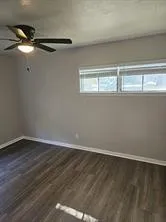a view of a room with wooden floor
