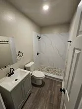 a bathroom with a sink toilet and shower