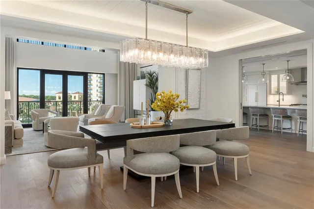 a view of a dining room with furniture wooden floor and chandelier