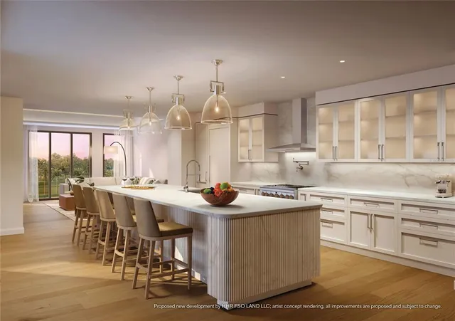 a kitchen with stainless steel appliances granite countertop a stove and white cabinets
