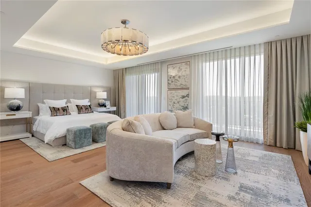 a spacious bedroom with a bed and a large window