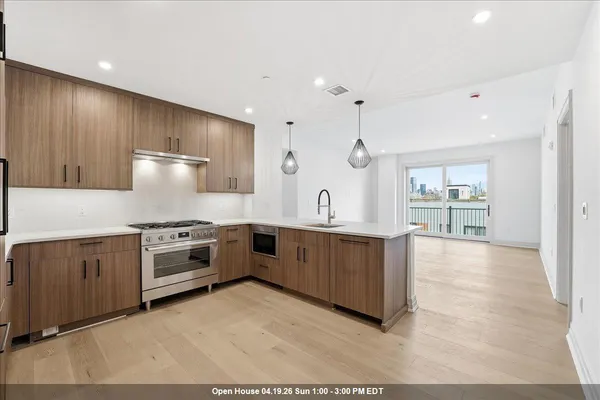 a kitchen with sink refrigerator and stove