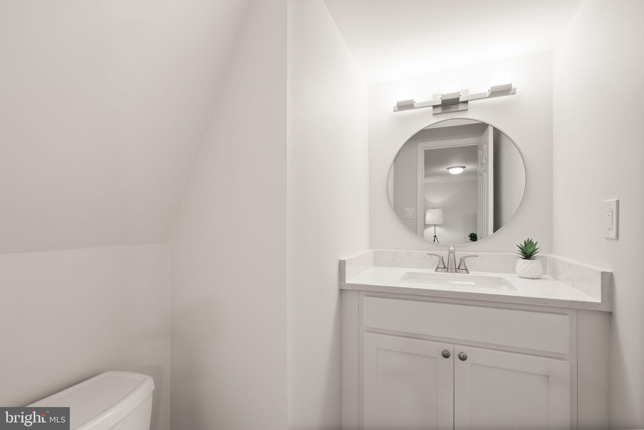 6369 English Ivy Way Springfield, VA 22152 - Photo 51 of 62 a bathroom with a toilet sink and mirror