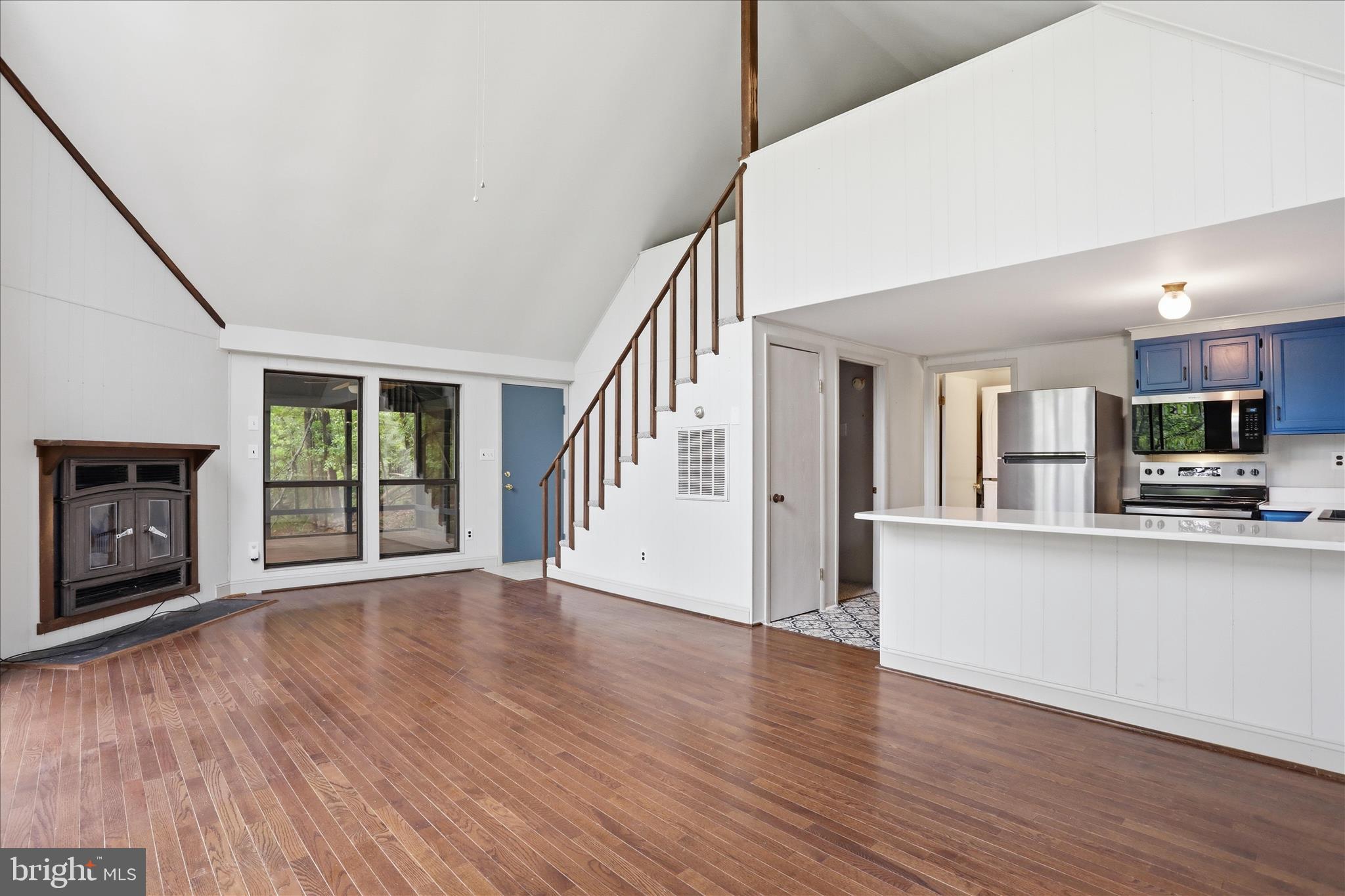 578 Walden Road Hedgesville, WV 25427 - Photo 8 of 39 a view of an empty room with wooden floor and a kitchen