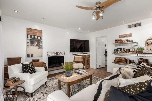 a living room with furniture a fireplace and a flat screen tv