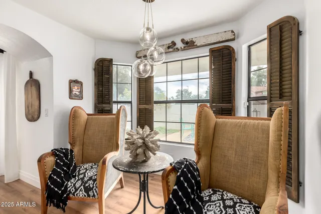 a living room with furniture chandelier and a window