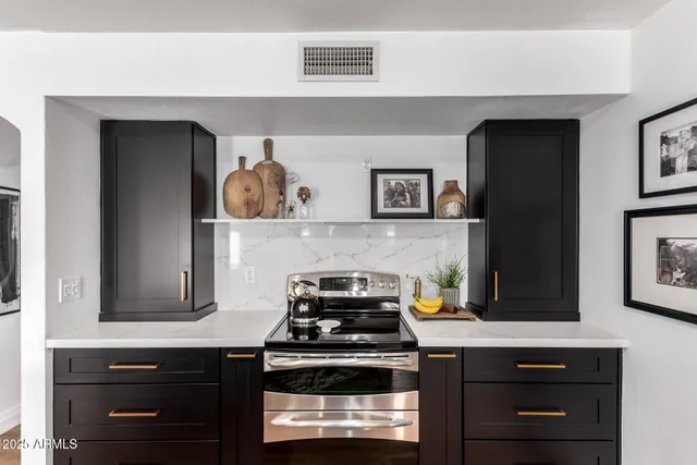 a kitchen with a stove and cabinets
