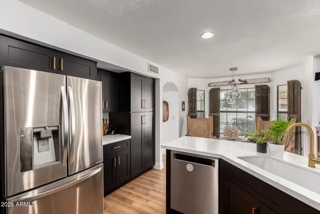 a kitchen with stainless steel appliances a refrigerator and sink