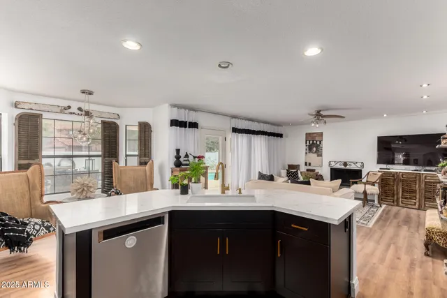 a kitchen with a sink cabinets and wooden floor
