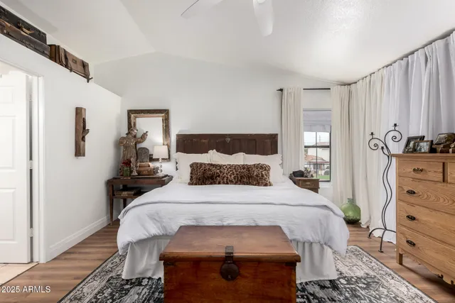 a bedroom with a bed and wooden floor
