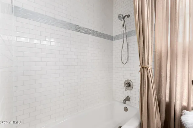 a bathroom with a bath tub and shower