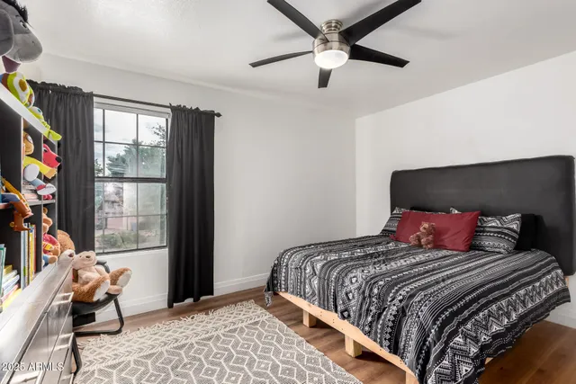 a bedroom with a bed and a window