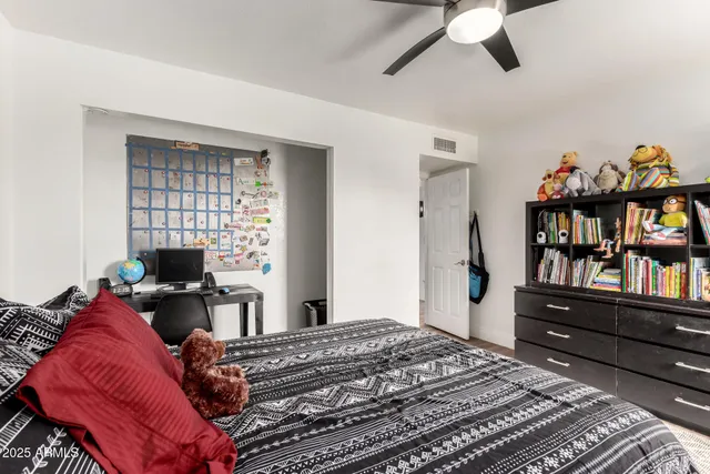 a bed room with a bed and a book shelf