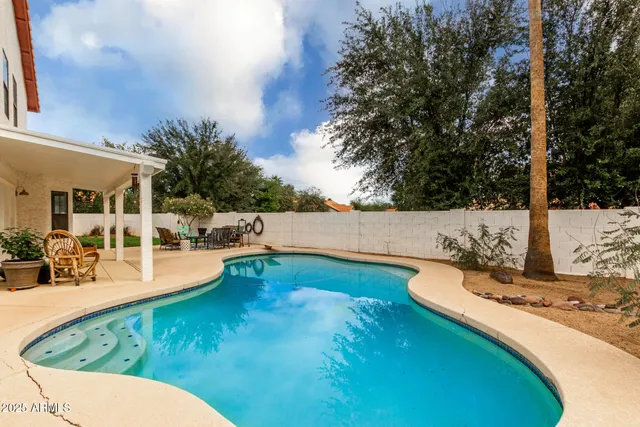 a view of a swimming pool with a patio