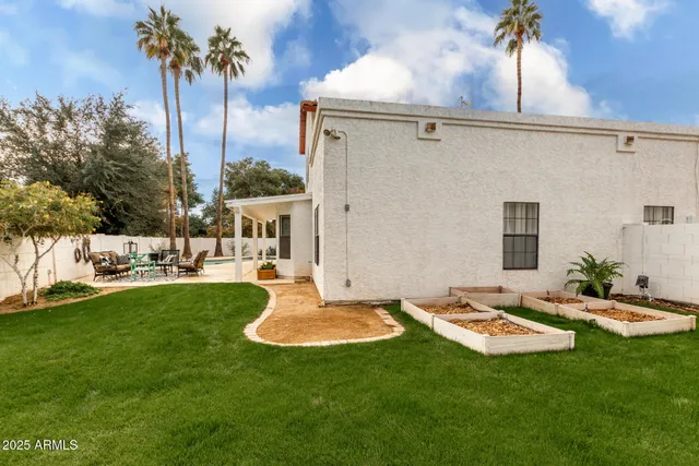 a backyard of a house with table and chairs