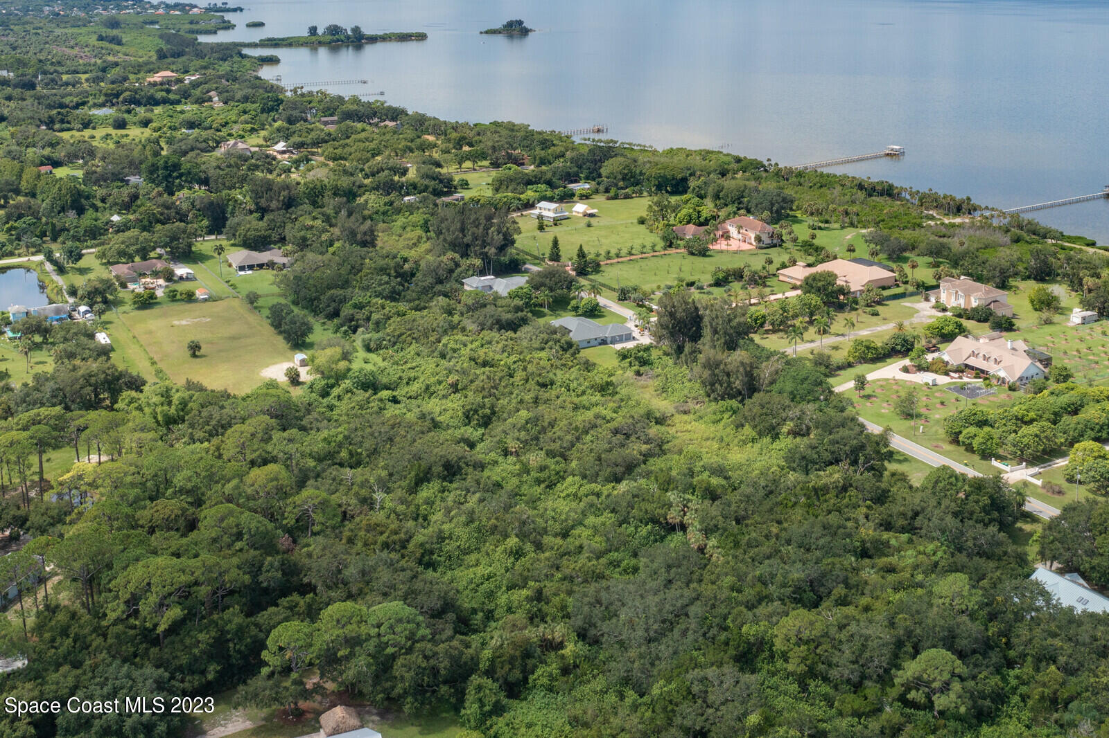 0 West Crisafulli Road Merritt Island, FL 32953 - Photo 8 of 11 an aerial view of residential houses with outdoor space and trees