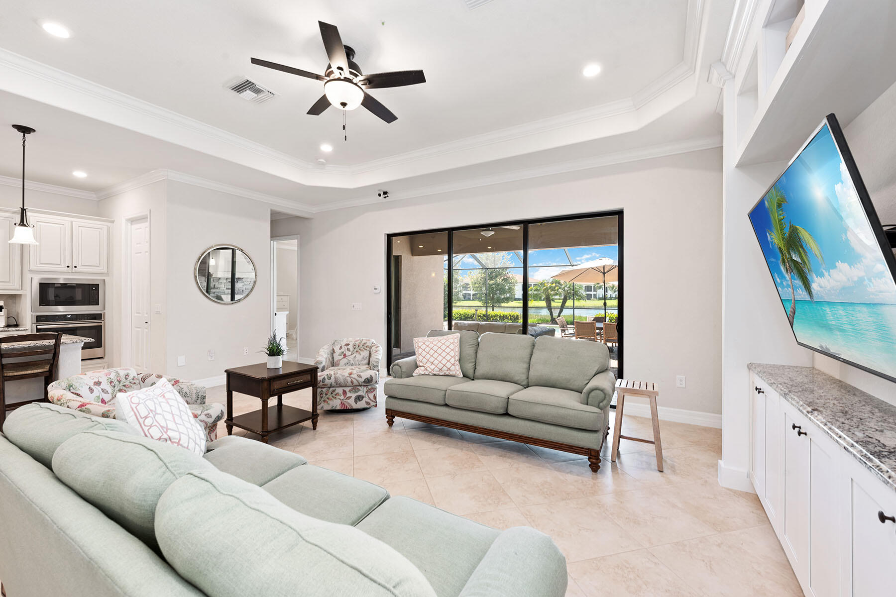3009 Aviamar Circle Naples, FL 34114 - Photo 2 of 50 a living room with furniture and a flat screen tv