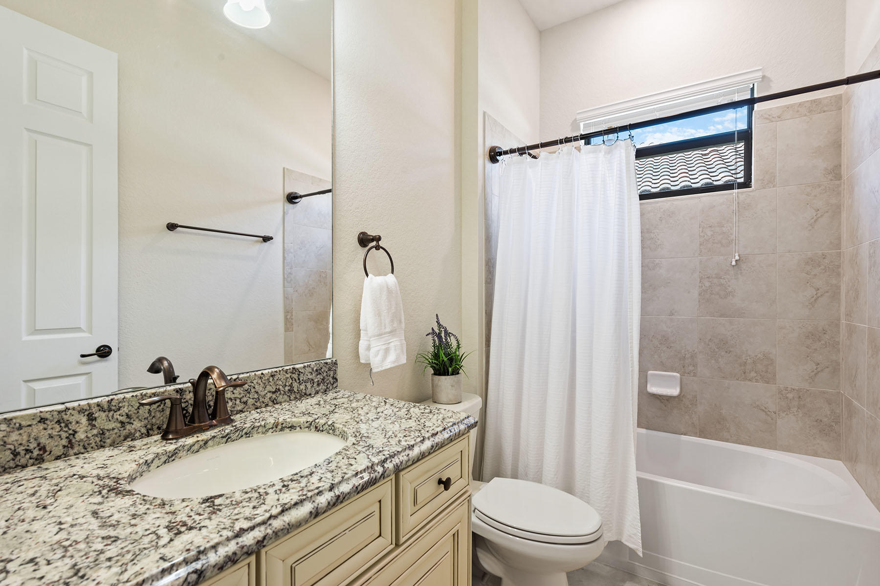 3009 Aviamar Circle Naples, FL 34114 - Photo 13 of 50 a bathroom with a granite countertop sink toilet and shower