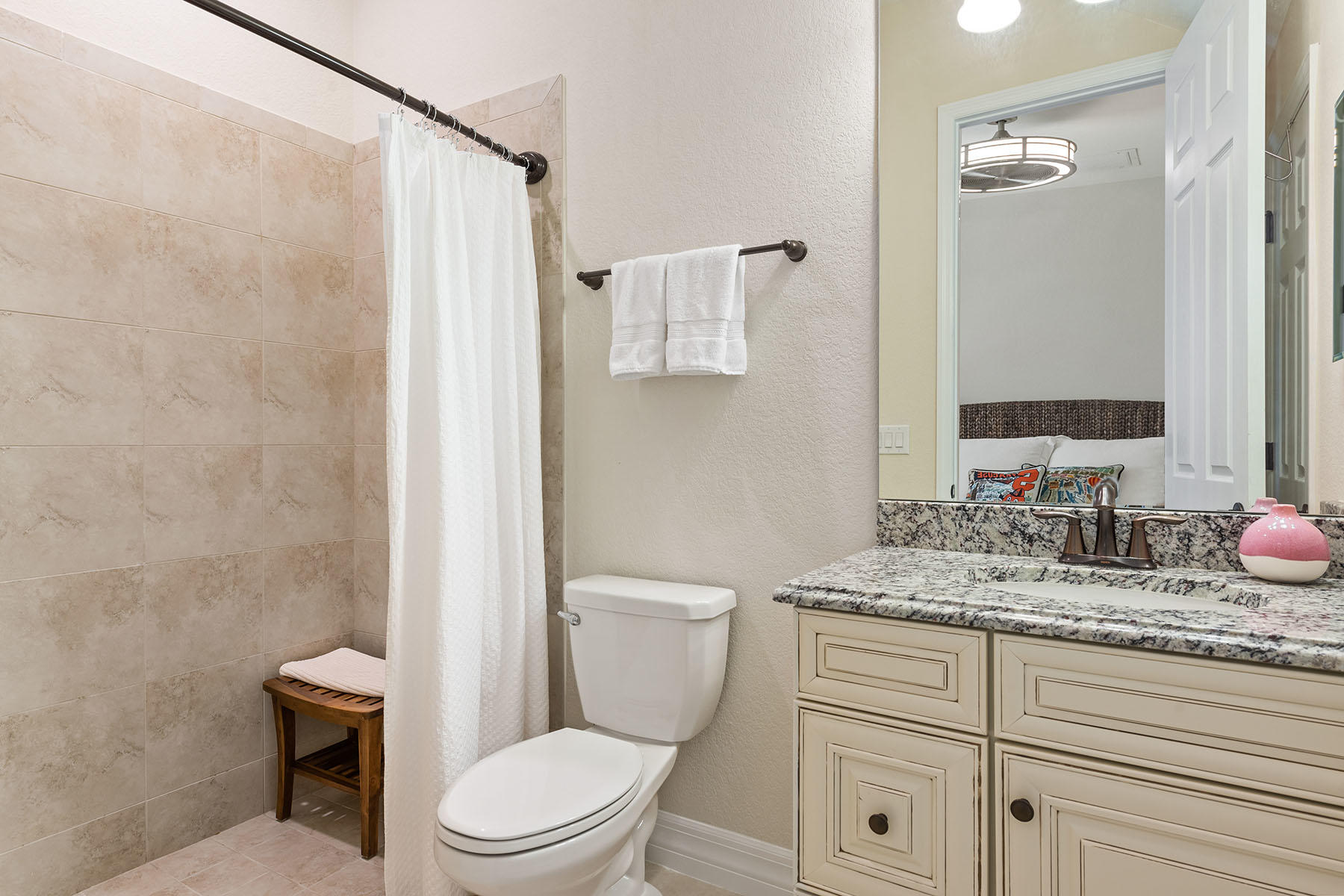 3009 Aviamar Circle Naples, FL 34114 - Photo 15 of 50 a bathroom with a granite countertop toilet sink and mirror