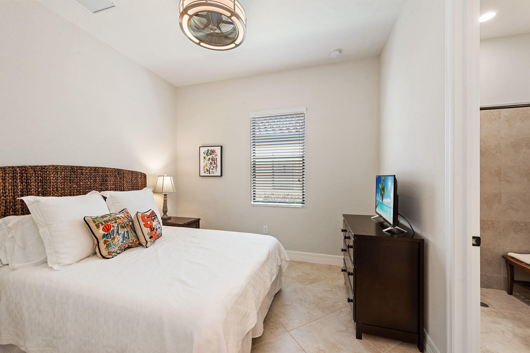 3009 Aviamar Circle Naples, FL 34114 - Photo 16 of 50 a bedroom with a bed and a television