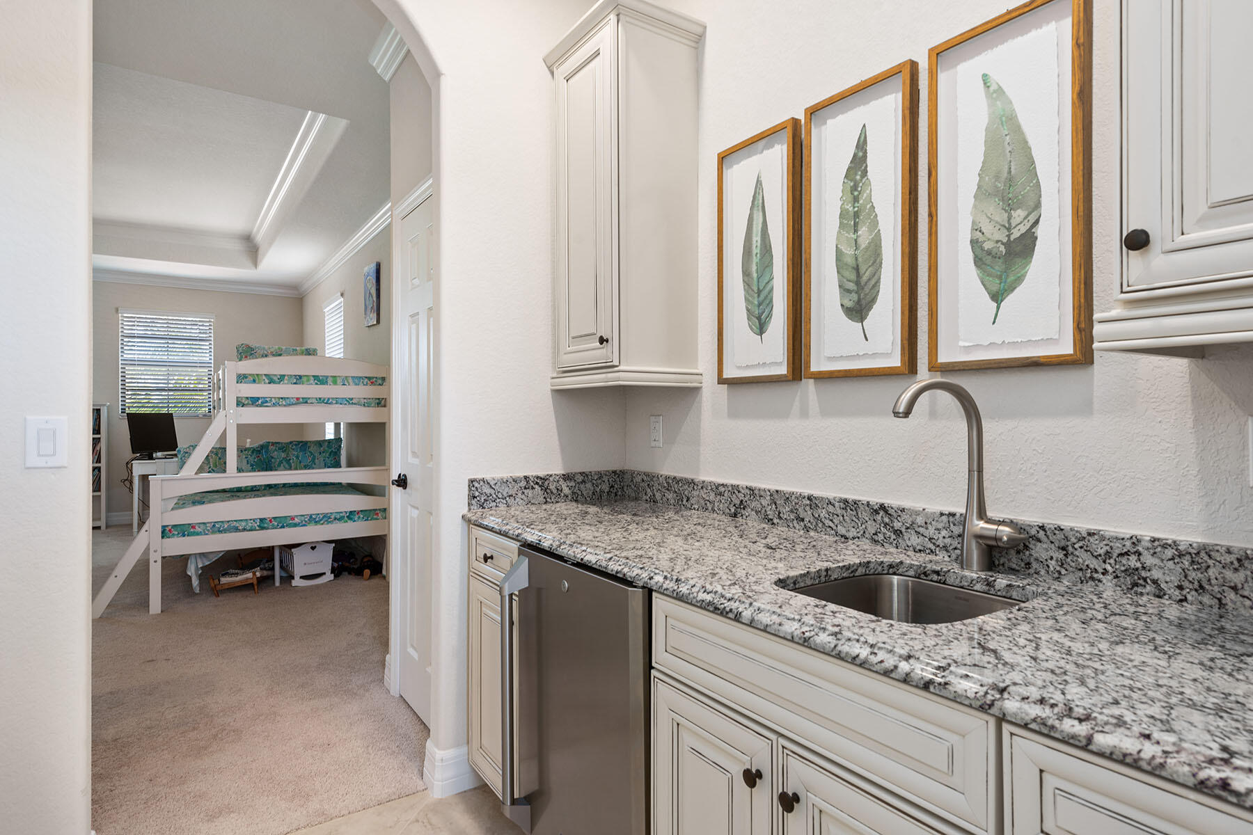 3009 Aviamar Circle Naples, FL 34114 - Photo 18 of 50 a kitchen with stainless steel appliances granite countertop a sink and a wooden cabinets