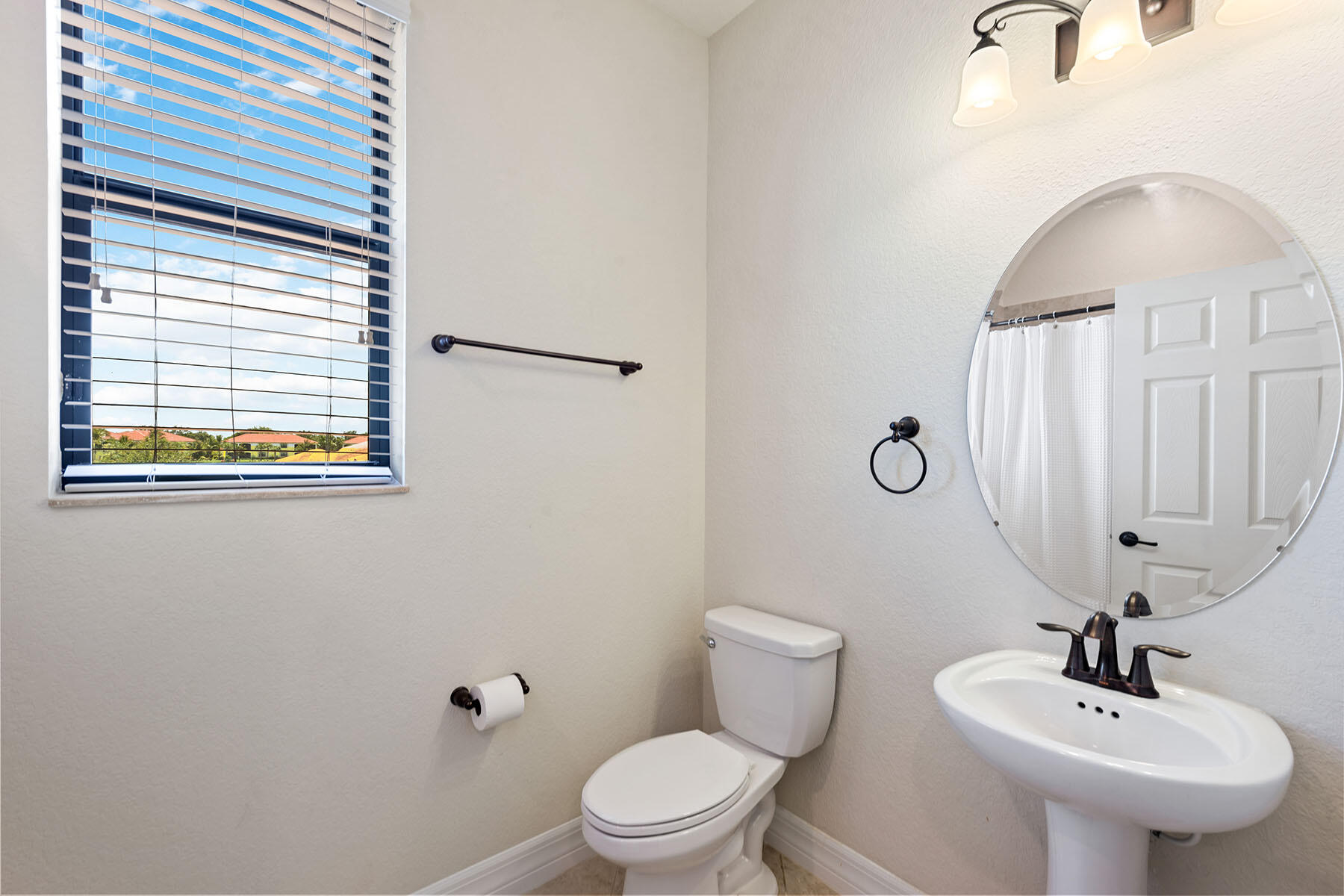 3009 Aviamar Circle Naples, FL 34114 - Photo 19 of 50 a bathroom with a toilet sink and mirror