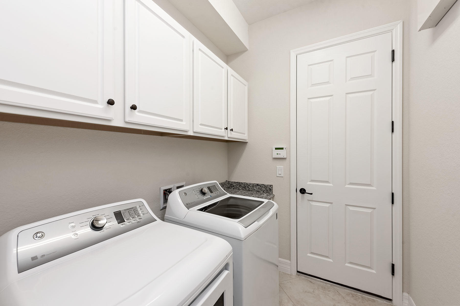 3009 Aviamar Circle Naples, FL 34114 - Photo 20 of 50 a utility room with dryer and washer