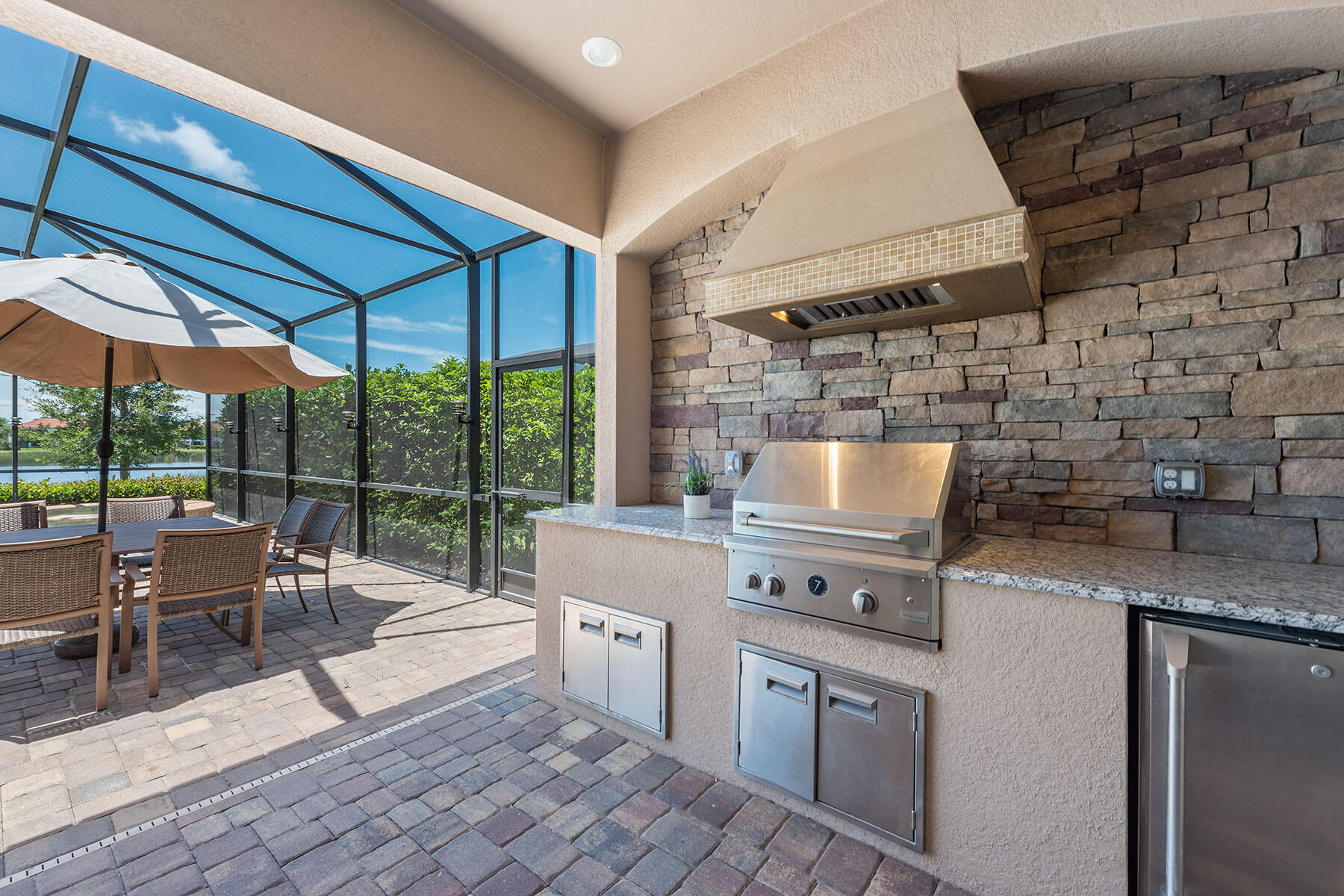 3009 Aviamar Circle Naples, FL 34114 - Photo 22 of 50 a kitchen with stainless steel appliances granite countertop a stove a sink and white cabinets