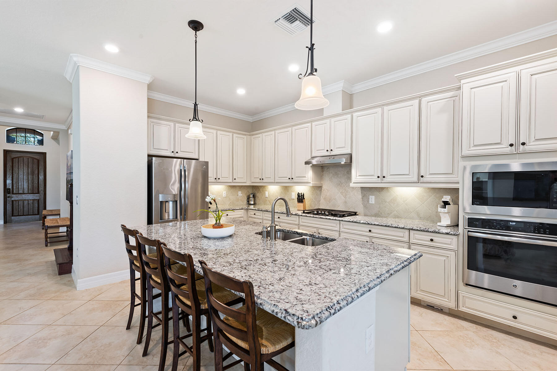 3009 Aviamar Circle Naples, FL 34114 - Photo 6 of 50 a kitchen with stainless steel appliances granite countertop a kitchen island a stove a table and chairs