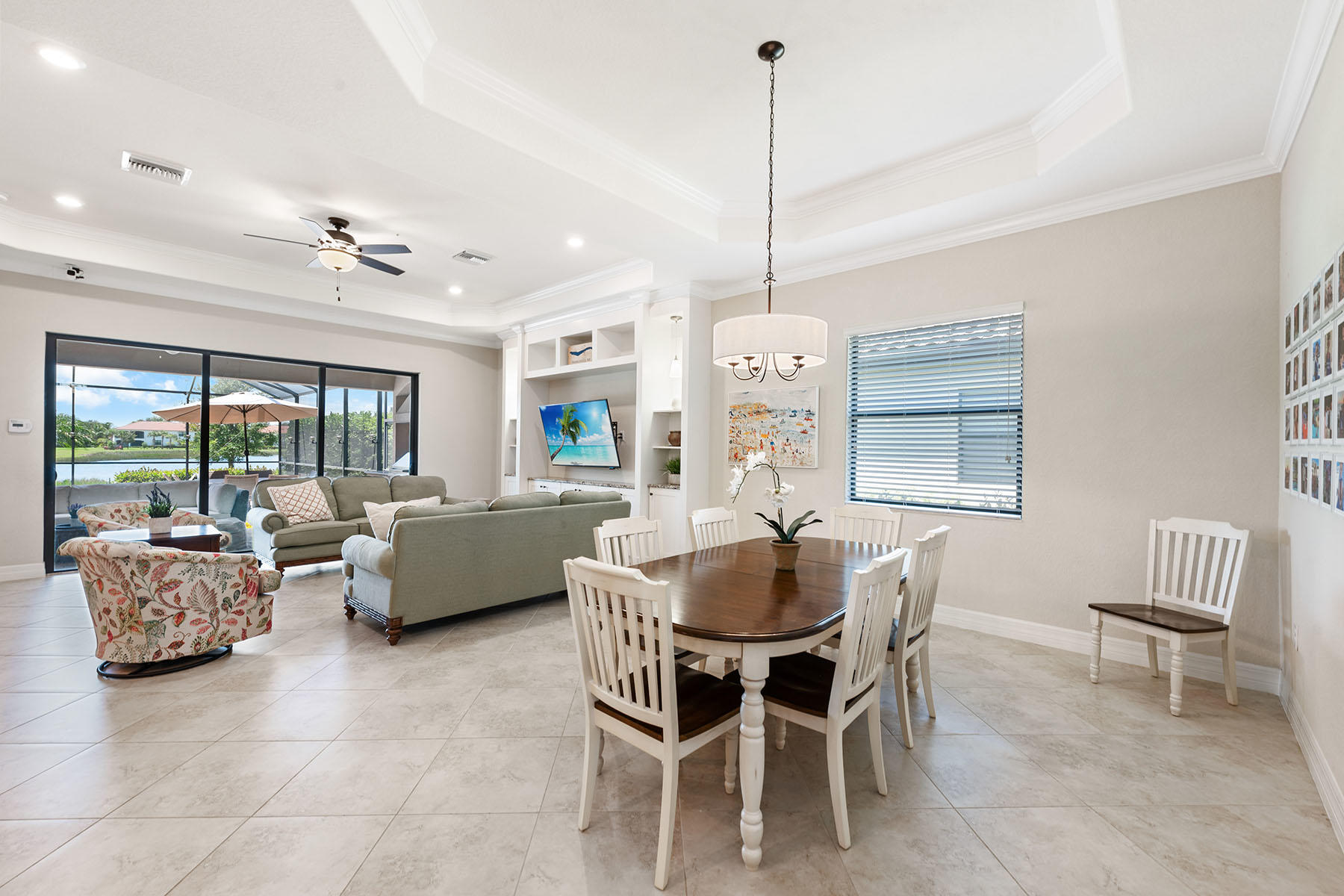3009 Aviamar Circle Naples, FL 34114 - Photo 8 of 50 a dining room with furniture a chandelier and wooden floor