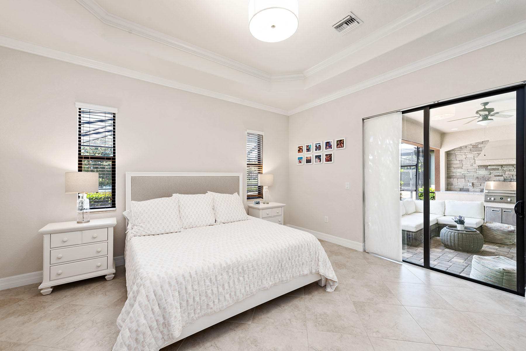 3009 Aviamar Circle Naples, FL 34114 - Photo 10 of 50 a bedroom with a bed a table and a large window