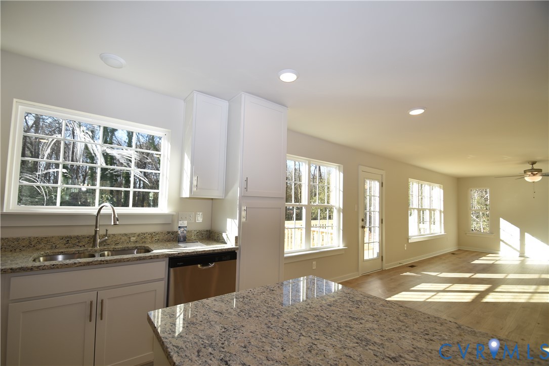 7014 Woodside Street Henrico, VA 23231 - Photo 7 of 13 a kitchen with granite countertop sink and window