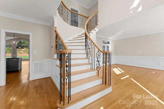 a view of entryway and hall with wooden floor