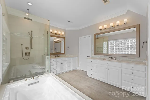 a bathroom with double sink and a mirror