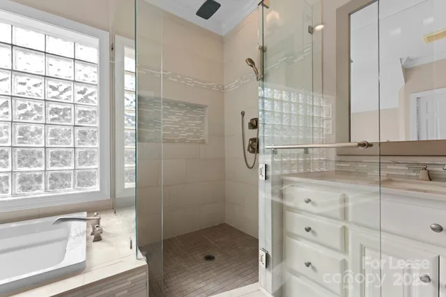 a bathroom with a shower and a sink