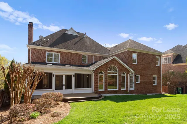 a front view of a house with a garden and yard
