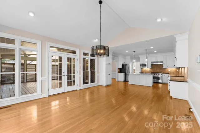 a view of a living room and kitchen floor to ceiling windows and kitchen view