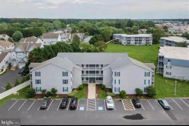 an aerial view of a house with porch and garden