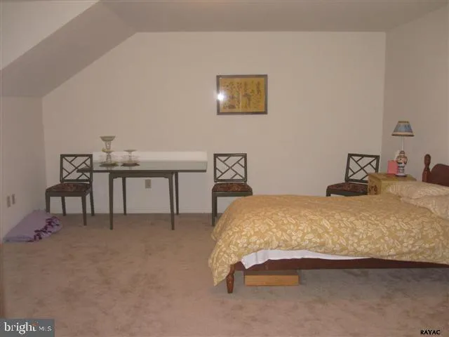 a bedroom with a bed and a table in it