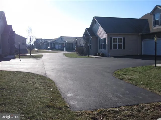 a view of a house with backyard and a tree