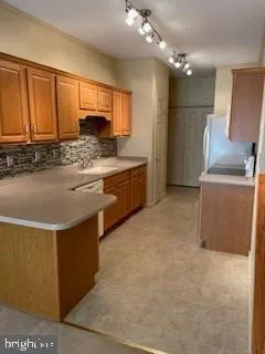 a large kitchen with cabinets and stainless steel appliances