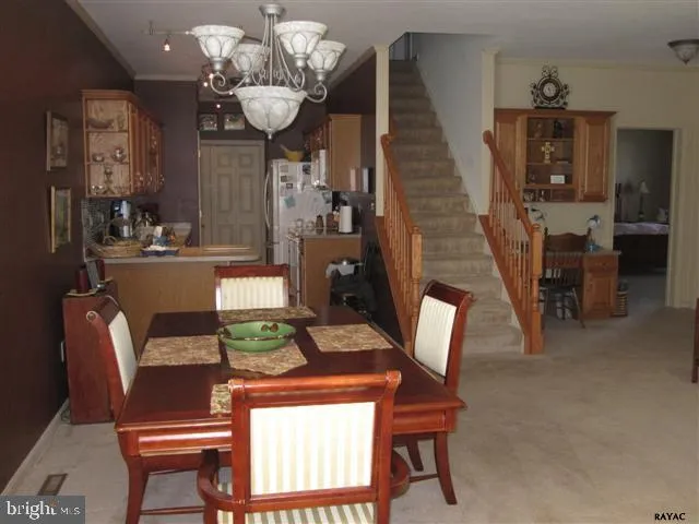a view of a dining room with furniture and chandelier