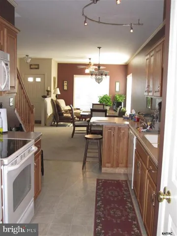 a large room with lots of counter space and chandelier